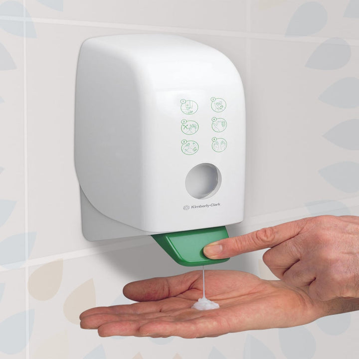 A Person Using a White and Green Kimberly-Clark 6373 Hand Wash Dispenser