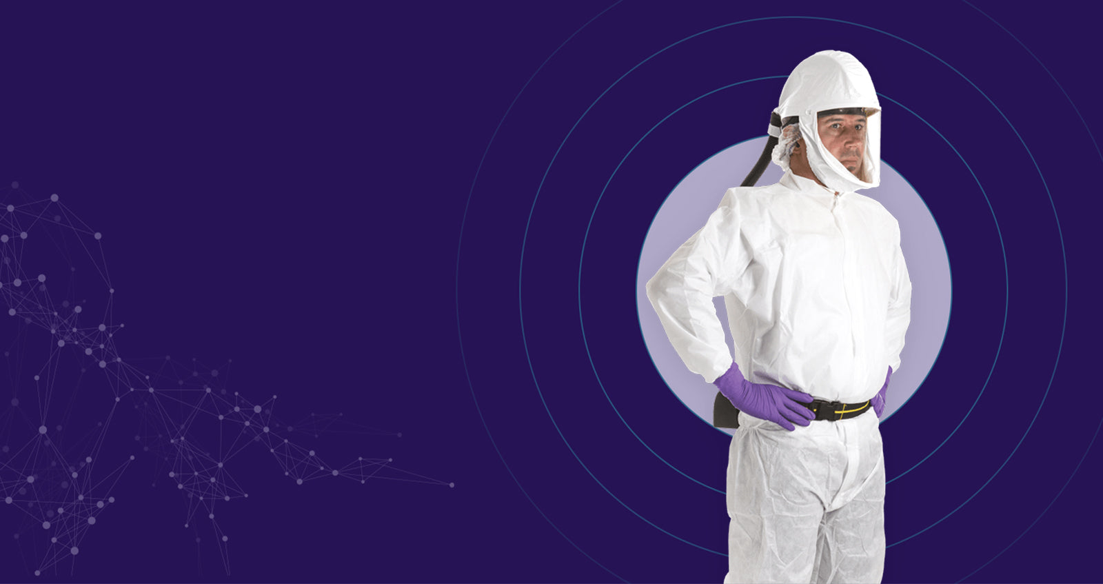 Purple Background with a man wearing a disposable coverall and powered respirator 