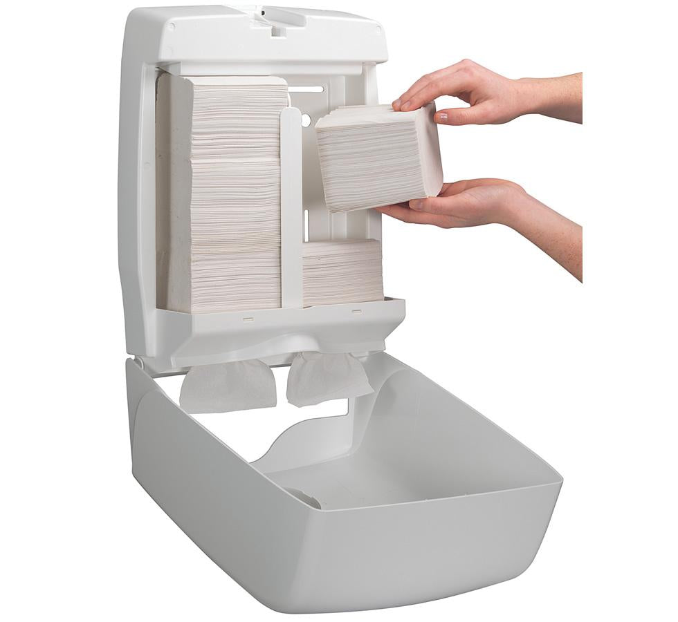 A Person Using a White 6990 AQUARIUS* Toilet Tissue Paper Dispenser, Bulk Pack - White - Sentinel Laboratories Ltd