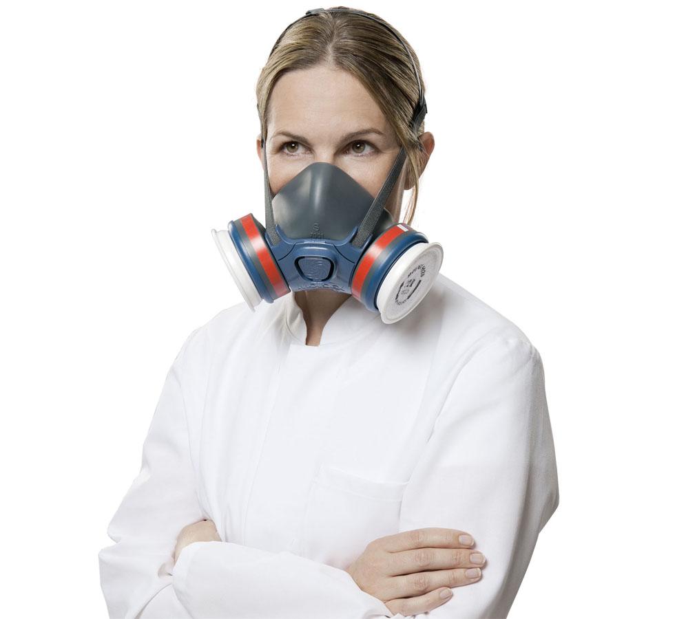 A Woman with Blonde Hair Wearing a White Lab Coat and Grey, Red and Blue Moldex Series 7000 Reusable Half Mask with EasyLock® connectors - Sentinel Laboratories Ltd