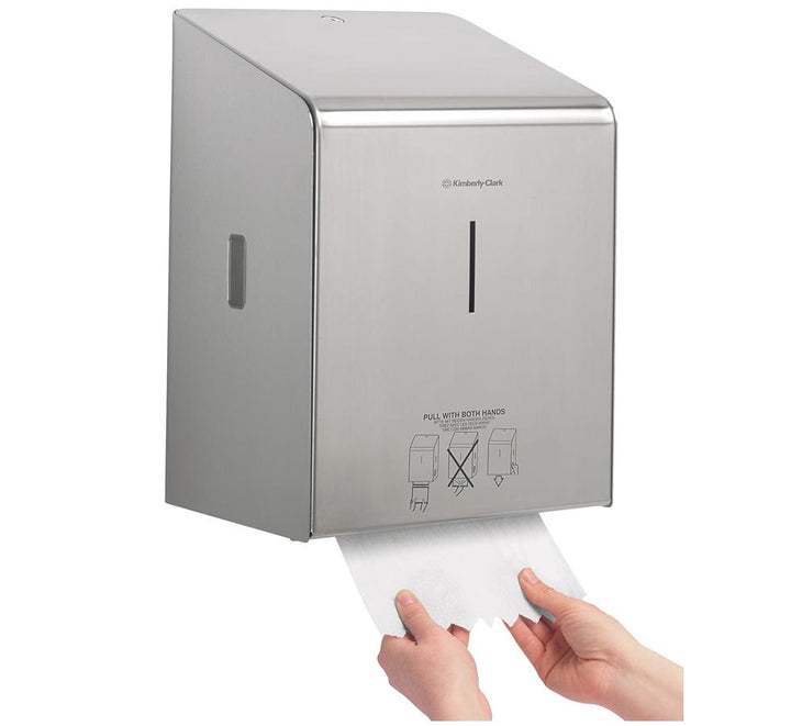 A Person Pulling a White Paper Hand Towel From a Metallic 8976 KIMBERLY-CLARK PROFESSIONAL* Rolled Hand Towel Dispenser - Stainless Steel - Sentinel Laboratories Ltd