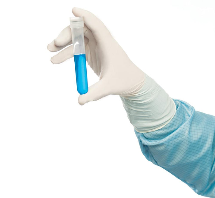 A Person Wearing a Blue Lab Coat Wearing a Single White Long Length Cuff BioClean Excell™ Sterile 300mm Length Nitrile Glove Holding a Vial of Blue Liquid - Sentinel Laboratories Ltd
