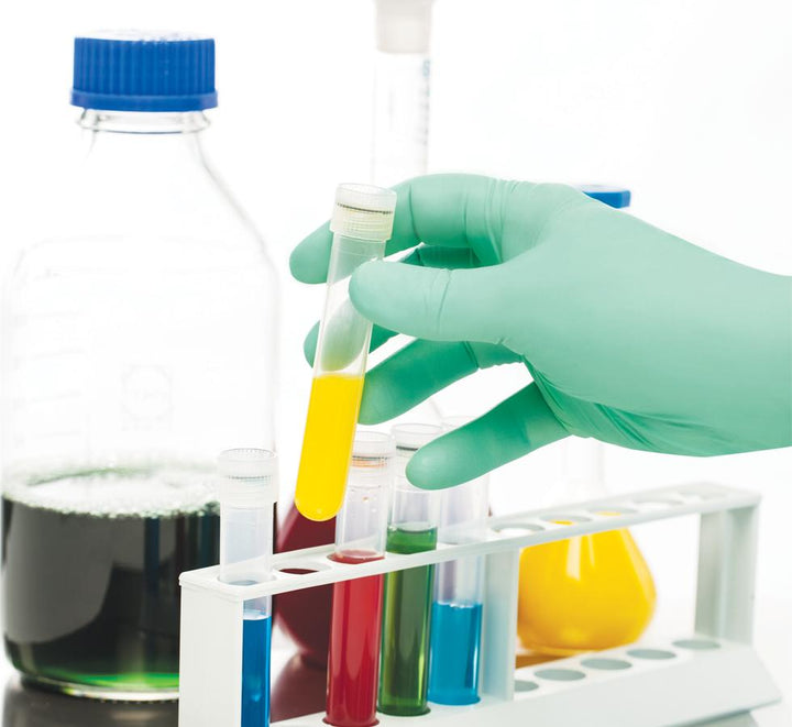 A Person Wearing a Single Green BioClean Fusion™ Sterile 300mm Length Polychloroprene Glove Sorting a Variety of Coloured Vials - Sentinel Laboratories Ltd
