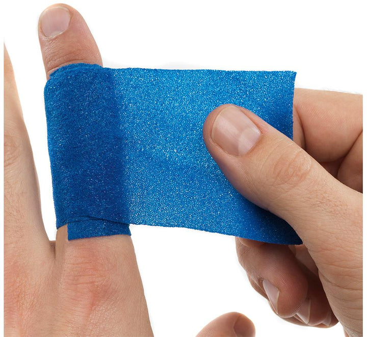 A Person Applying a Blue Cederroth Soft Foam Bandage to their Index Finger - Blue - Sentinel Laboratories Ltd