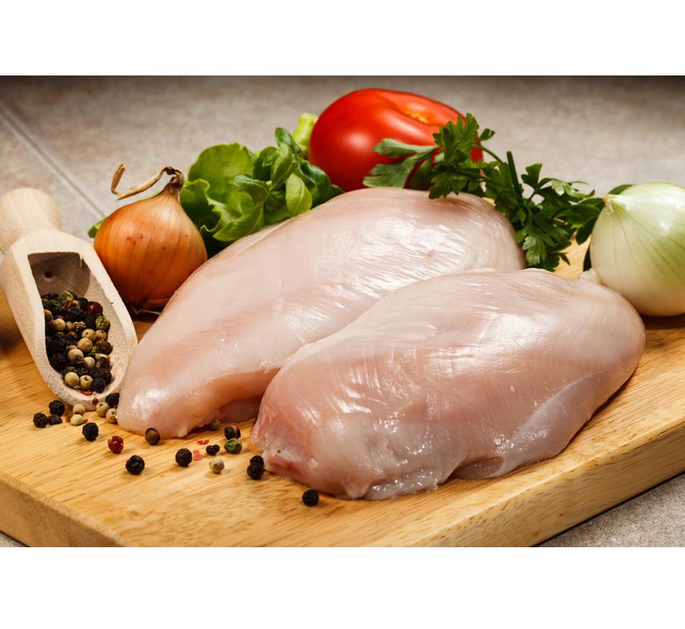 Two chicken breasts with vegetables on a wooden chopping board - Food Safety in Catering - Level 2 - Sentinel Laboratories Ltd