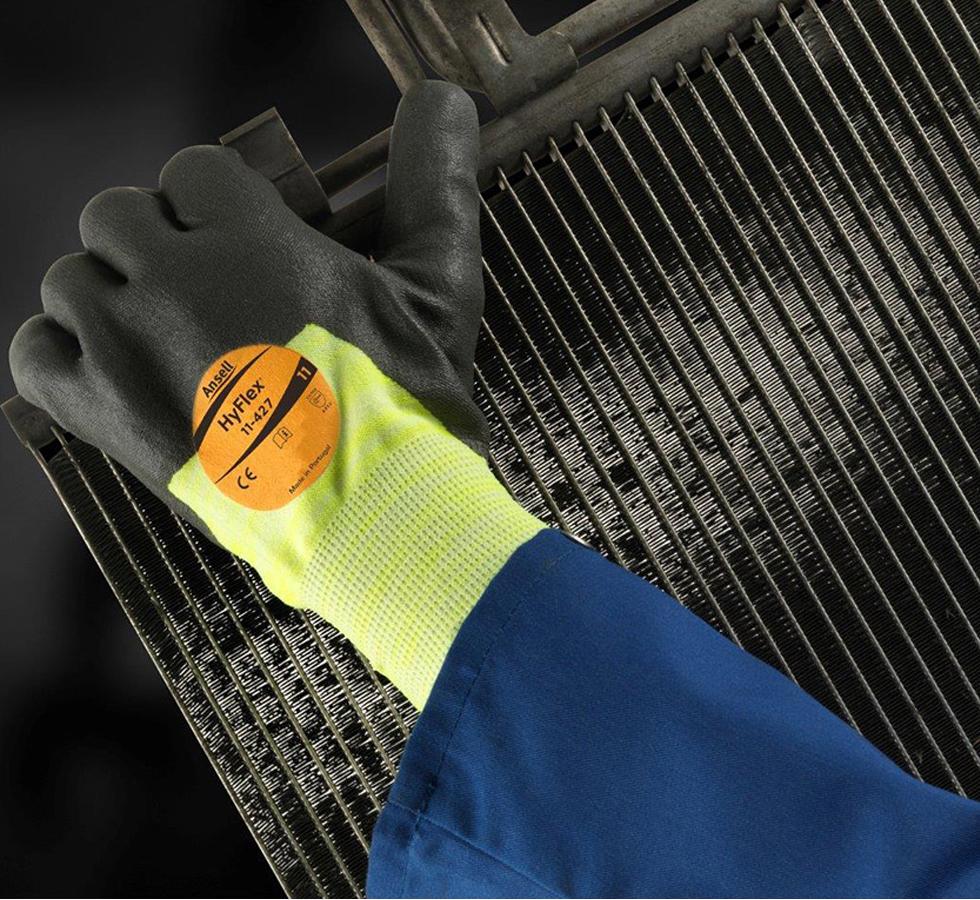 Person Wearing A Blue Jacket and Black, Fluorescent Green HYFLEX® 11-427 (Previously Puretough™ P3000 Tropique) Gloves Holding a Piece of Machinery - Sentinel Laboratories Ltd