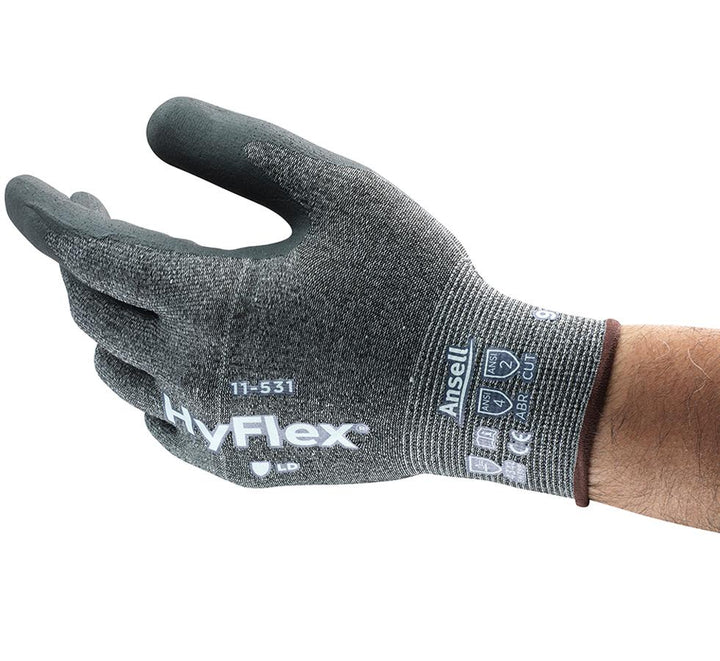 Man Wearing a Single Grey Knitted HYFLEX® 11-531 Industrial Glove - Brown Beaded and White Lettering - Sentinel Laboratories Ltd