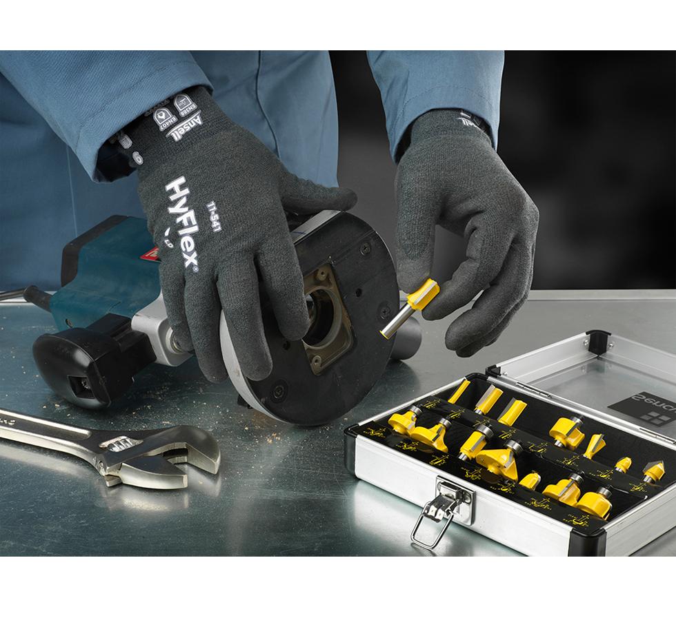 A Person Wearing a Pair of Black HYFLEX® 11-541 Gloves Holding a Machine with Sockets and  Wrench - Sentinel Laboratories Ltd