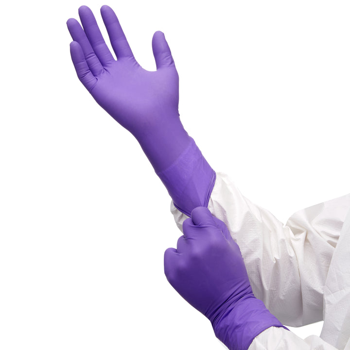 A Person in a White Coverall Donning a Pair of N50601 Purple Nitrile Gloves