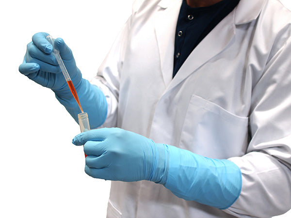 A Person In a White Coverall Wearing a Pair of Blue BioClean™ Nerva Nitrile Blue ONAB Non Sterile Gloves Transferring Orange Liquid from a Pipette To a Vial