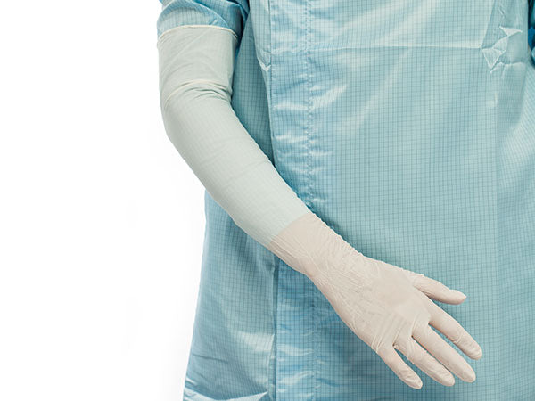 A Person in a Blue Coverall Wearing a BioClean Omega Nitrex Nitrile ONAL Non Sterile Glove