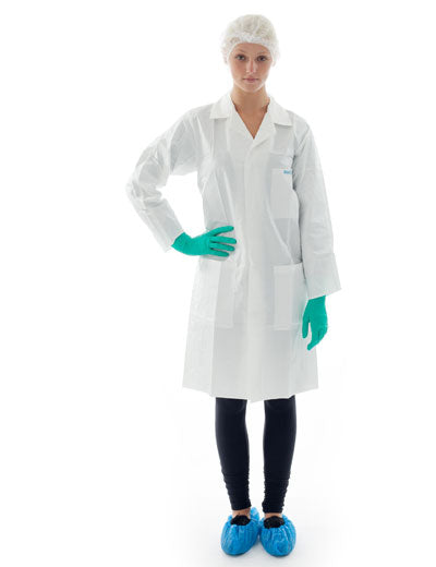 A Woman Wearing a White BioClean-D Sterile Lab Coat with Blue Overshoes, Green Gloves and A Hair Net