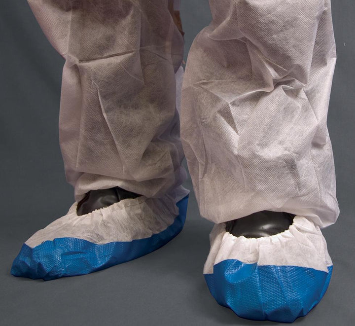 A Person Wearing White and Blue Shield DF02 CPE/Non-Woven Overshoes with White OverTrousers - Sentinel Laboratories Ltd