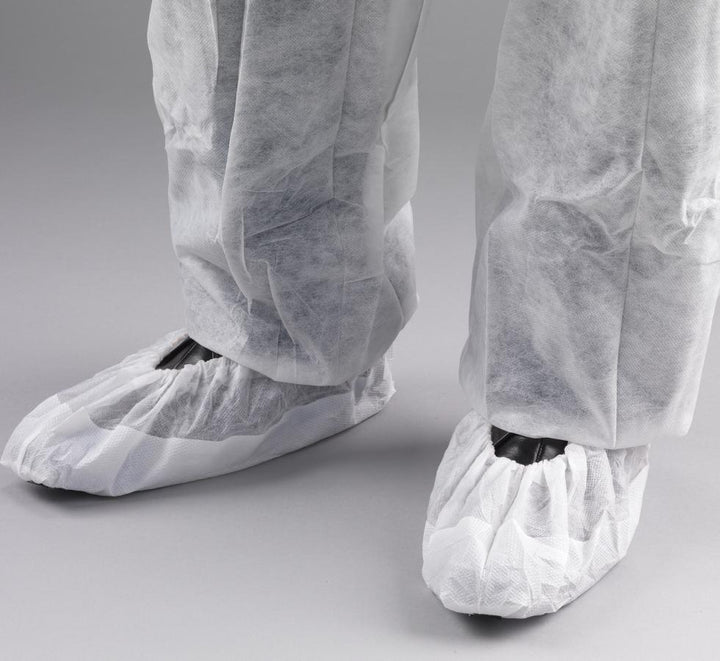 Black Mannequin wearing White Shield DF02 CPE/Non-Woven Overshoes with White Trousers - Sentinel Laboratories Ltd