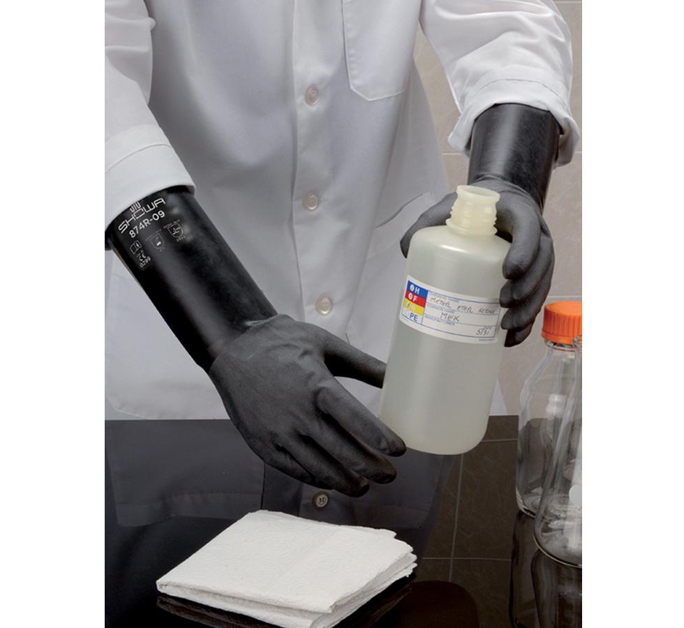 A Person Wearing a White Lab Coat Using Black Long Length Cuff Showa Best 874R Best® Butyl II Unlined Butyl Gloves Handling a Chemical Bottle, 0,35mm Thick, Rough - Sentinel Laboratories Ltd