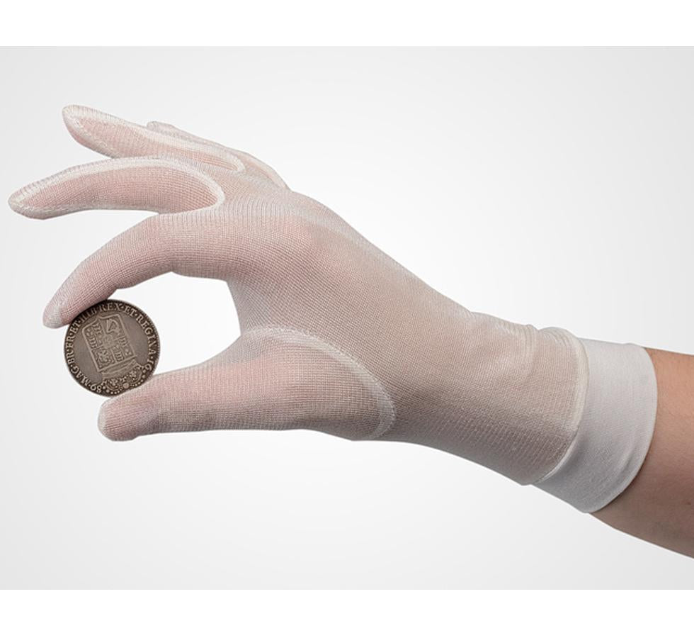 A Person Wearing a Single White Cuffed SENSI-TOUCH® Silk Glove Liner Holding a Bronze Coin - Sentinel Laboratories Ltd