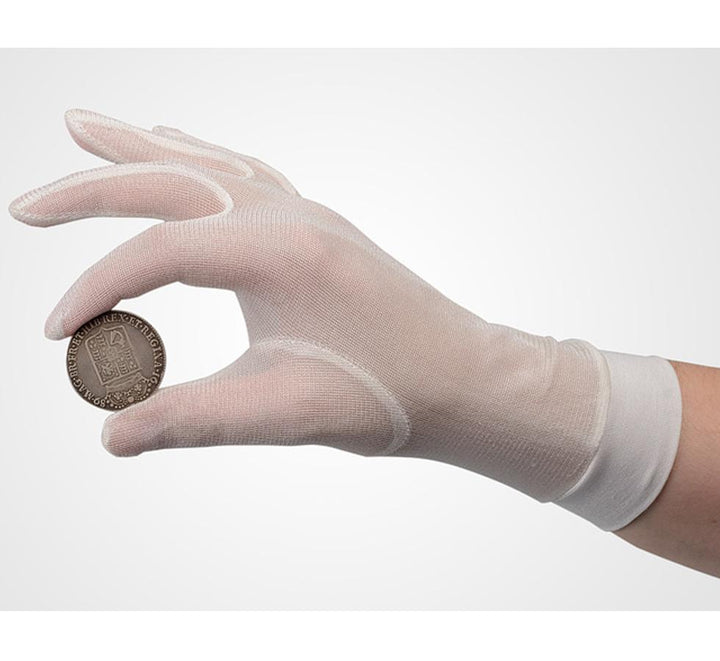 A Person Wearing a Single White Cuffed SENSI-TOUCH® Silk Glove Liner Holding a Bronze Coin - Sentinel Laboratories Ltd