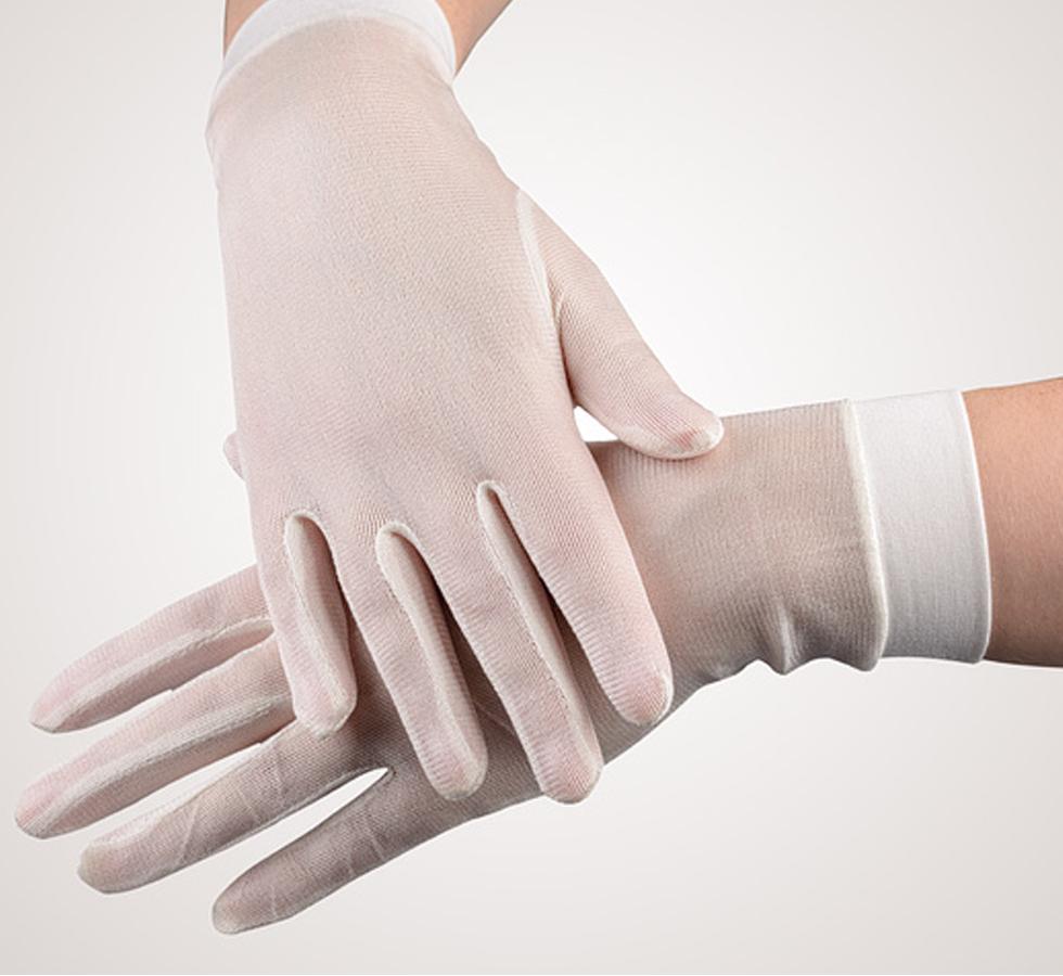 A Person Wearing a Pair of White SENSI-TOUCH® Silk Glove Liners, Cuffed - Sentinel Laboratories Ltd