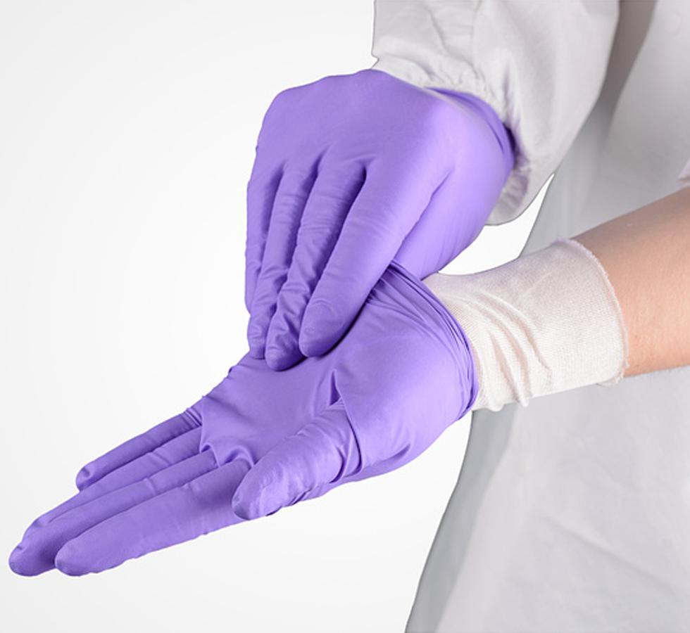 A Person wearing a Lab Coat with SENSI-TOUCH® Silk Glove Liners, Long Length Cuffs and Purple Nitrile Gloves - Sentinel Laboratories Ltd
