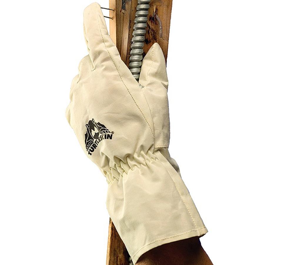 A Person Wearing a Single Cream Coloured TurtleSkin® FullCoverage Aramid Long Length Cuff Glove Holding a Metal Bar and Wooden Plank - Sentinel Laboratories Ltd
