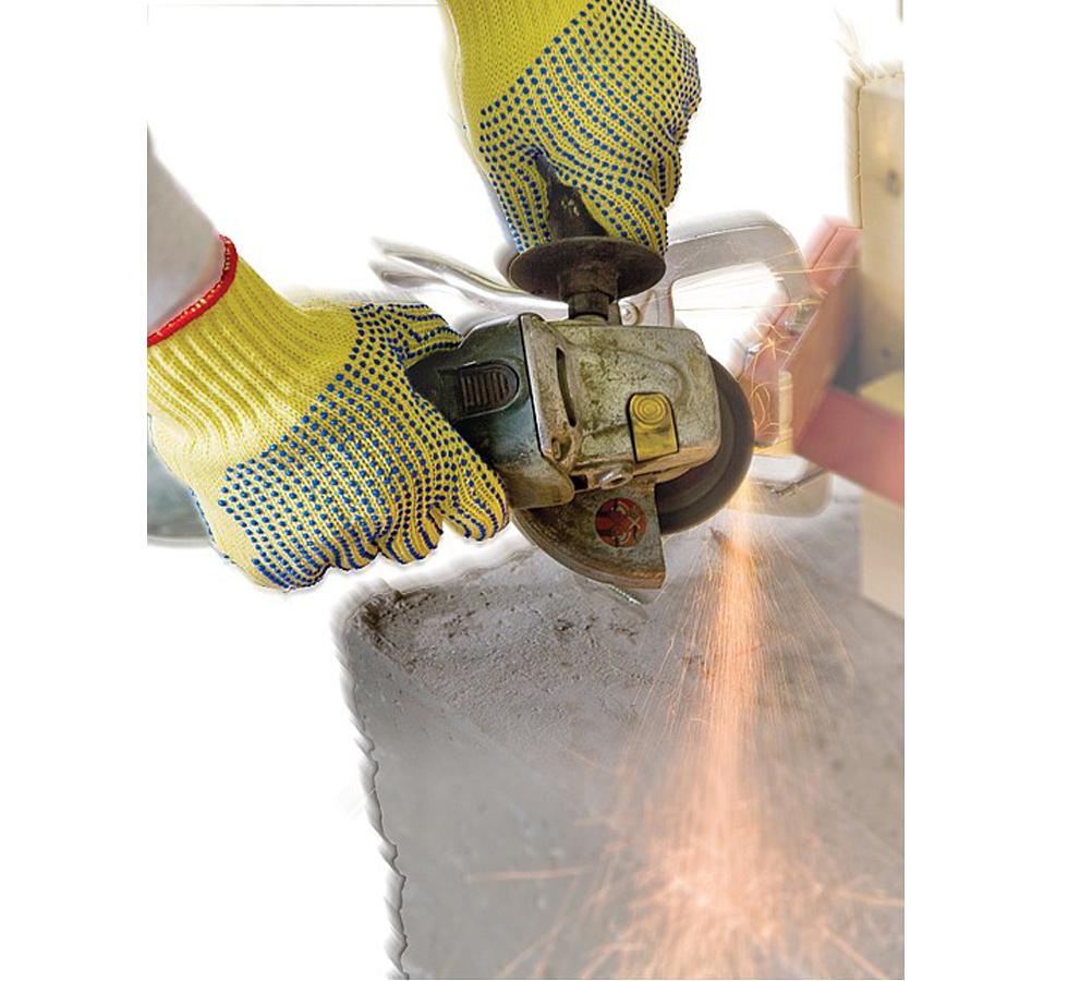 A Person Wearing a Pair of Yellow and Blue TurtleSkin® SafeHandler Gloves Holding and Using an Angle Grinder - Sentinel Laboratories Ltd