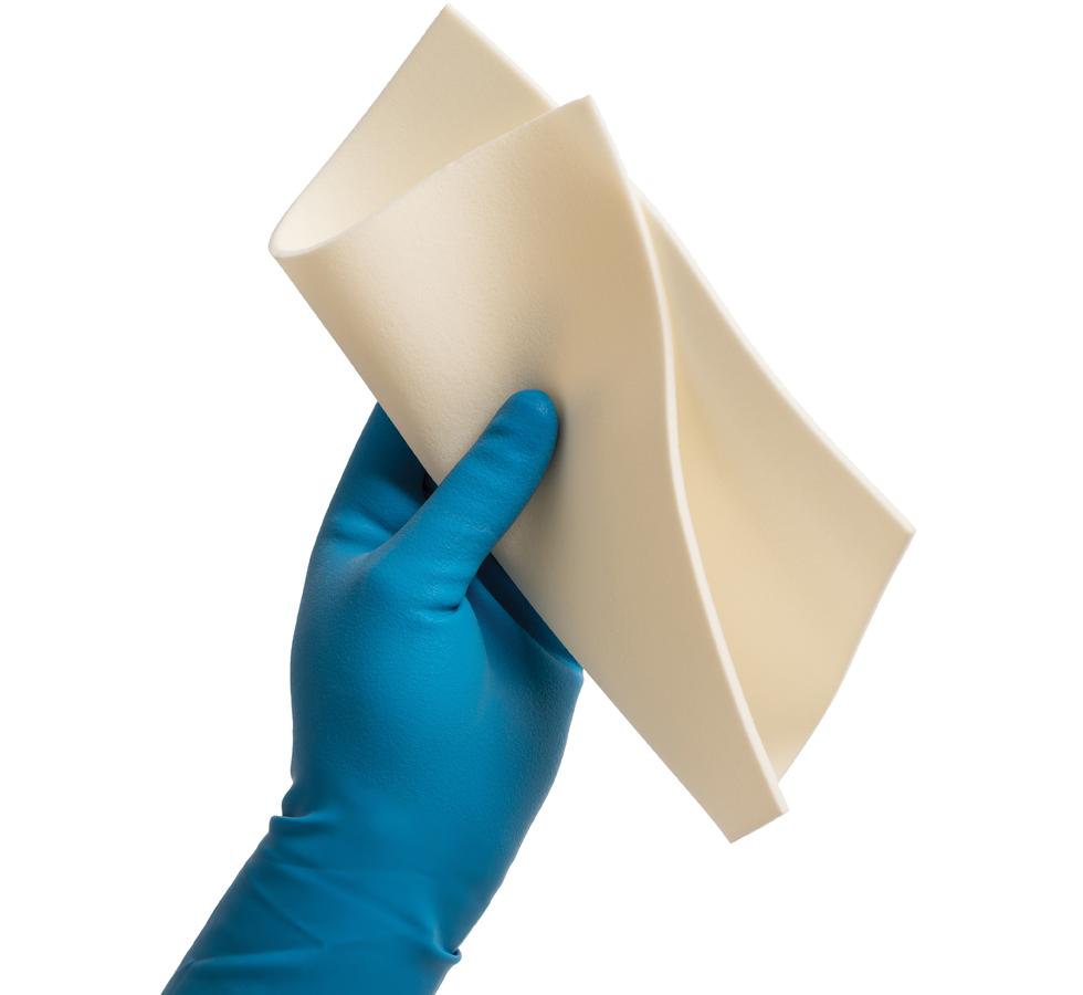A Person Wearing a Blue Glove Holding a Single SteriClean® Foam Wipe (23 x 23cm) - Sentinel Laboratories Ltd
