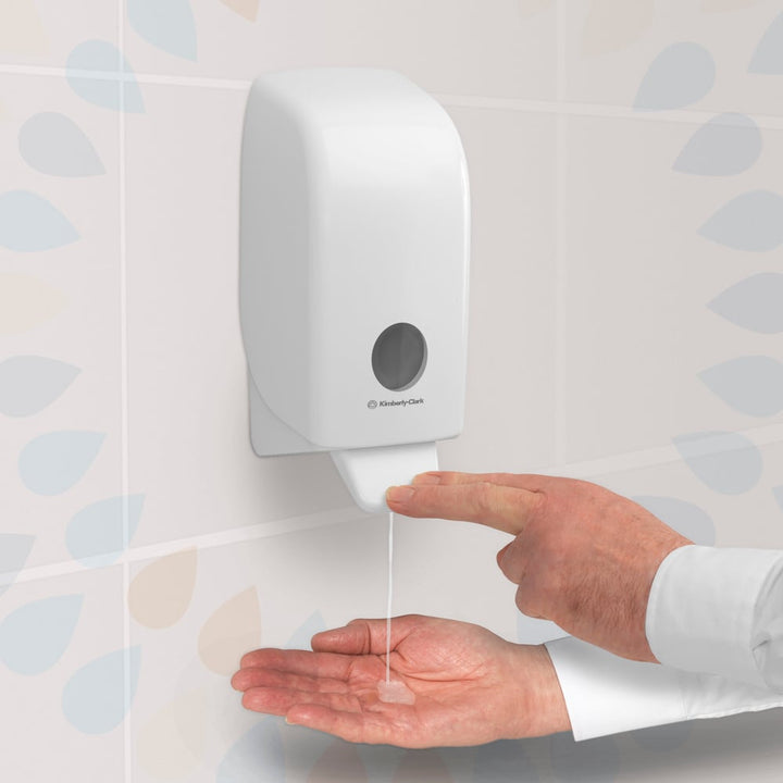 A Person Using a White 6382 Kimberly-Clark Hand Sanitiser Dispenser