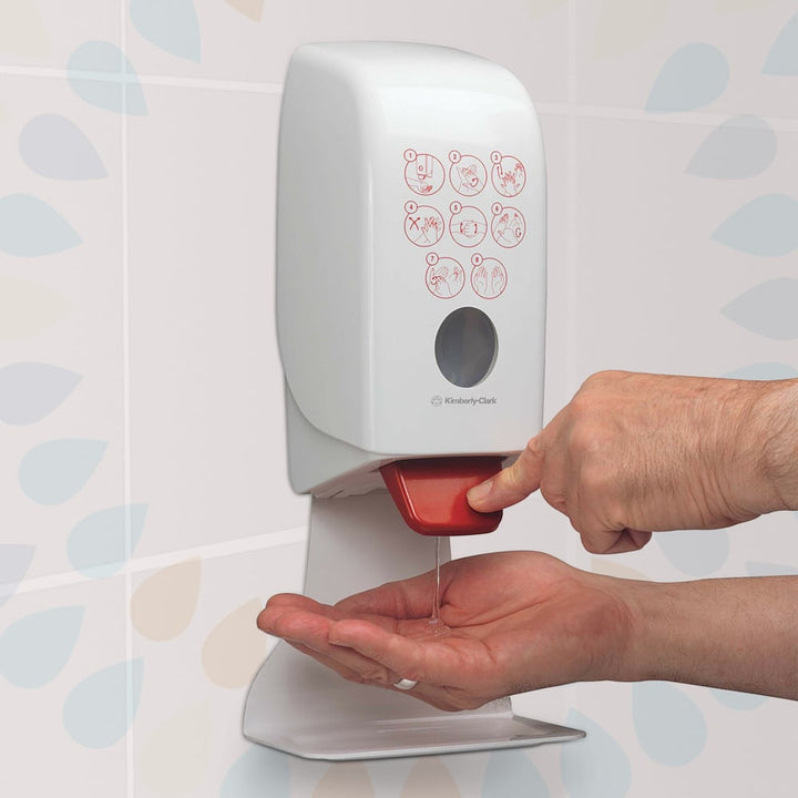 A Person Using a White and Red 6382 Kimberly-Clark Hand Sanitiser Dispenser with a Drip Tray