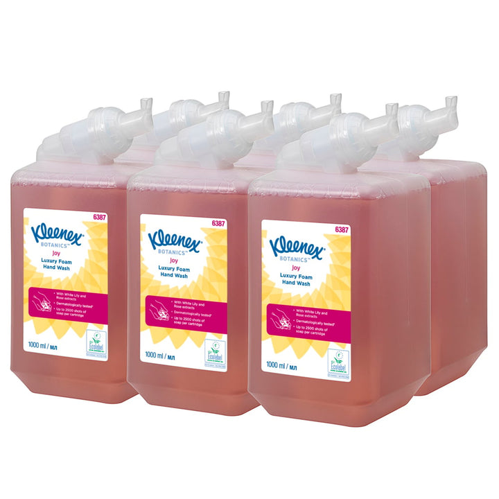 A Stack of Pink, White and Yellow 6387 Kleenex Professional Hand Cleanser Packs