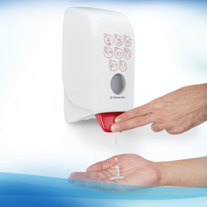 A Person Using a White and Red 6392 Scott Professional Control Hand Sanitiser