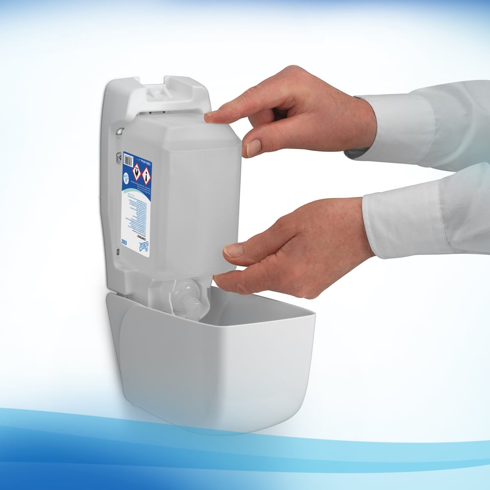 A Person Inserting a Clear, White and Blue Hand Sanitiser Refill into a White 6392 Hand Sanitiser Dispenser