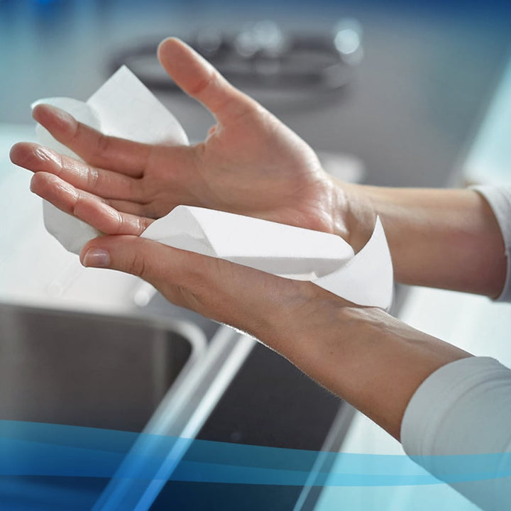 A Person Using a Single Scott 6636 White Paper Hand Towel