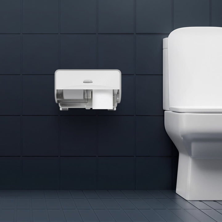 Two White Rolls of 8477 Kleenex Professional Toilet Paper in a White Dispenser in a Bathroom