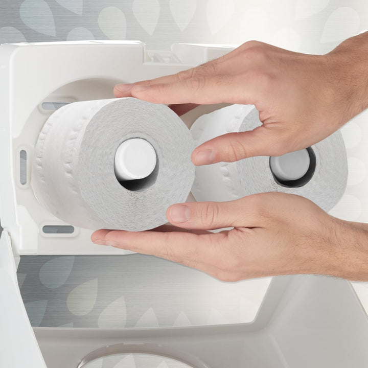 A Person Using a Roll of White 8477 Paper Tissue from a White Dispenser