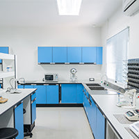 Image of a Laboratory with blue cupboards and scientific objects on the worktops
