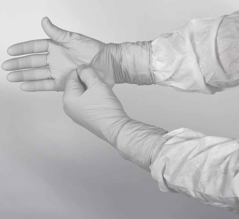 A Person Wearing a Pair of White 11821 KIMTECH PURE* G3 Sterile STERLING* Nitrile Gloves Over a White Lab Coat - Sentinel Laboratories Ltd
