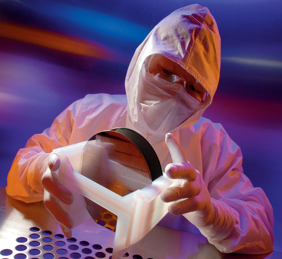 A Person Wearing a White KIMTECH PURE* A5 Sterile Hood, Coveralls, Mask and Clear Goggles Holding a White and Black Object  - One Size - Sentinel Laboratories Ltd