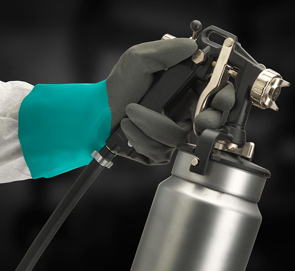 A Person Wearing a Dark Grey and Green Long Cuff ALPHATEC® 58-270 Nitrile Glove Using an Industrial Sprayer - Sentinel Laboratories Ltd