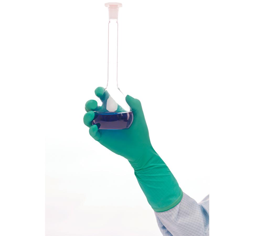 A Person Wearing a White Lab Coat Using a Single Green BioClean Synergy™ Non-Sterile 300mm Length Nitrile Glove Holding a Vial of Blue Liquid - Sentinel Laboratories Ltd