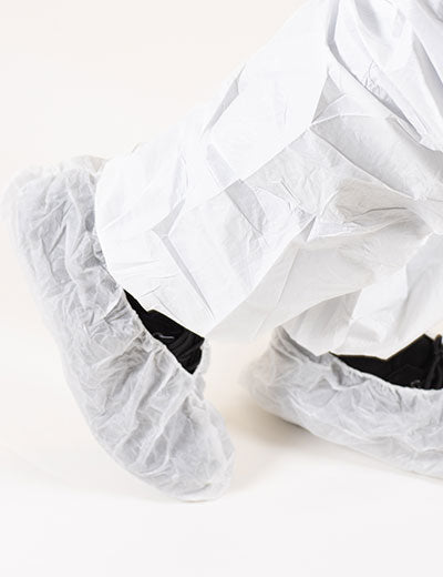 A Person Wearing a Pair of White BioClean SafeStep™ NSO Disposable Overshoes - Sentinel Laboratories Ltd
