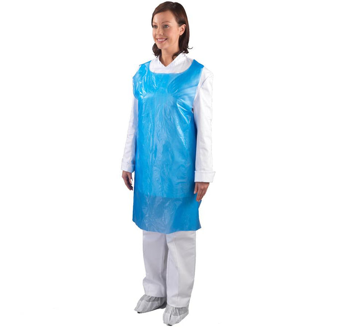 A Woman Wearing a Blue Shield 69 x 107cm Polythene Apron Over a White Coverall and Shoe Covers - Sentinel Laboratories Ltd