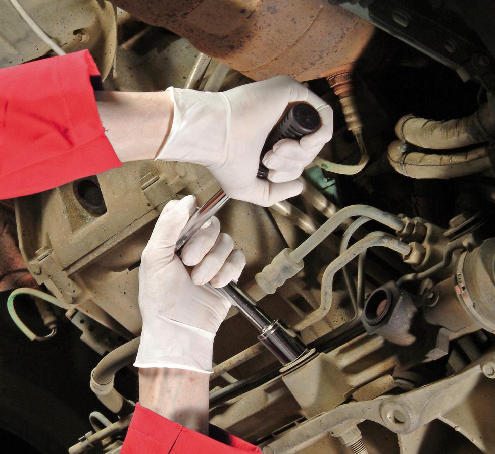 A Person Wearing a Pair of White Shield GD05 Powder Free Latex Disposable Gloves Using a Socket Wrench under a Car - Sentinel Laboratories Ltd
