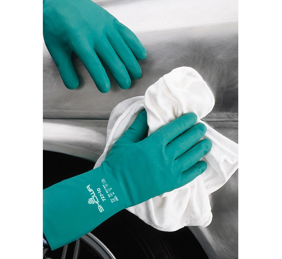 A Person Wearing a Pair of Green Showa Best 727 Nitri-Solve® Nitrile Long Length Cuff Gloves Using a White Cloth on a Metallic Car - Unlined 0,38mm thick, 330mm long - Sentinel Laboratories Ltd