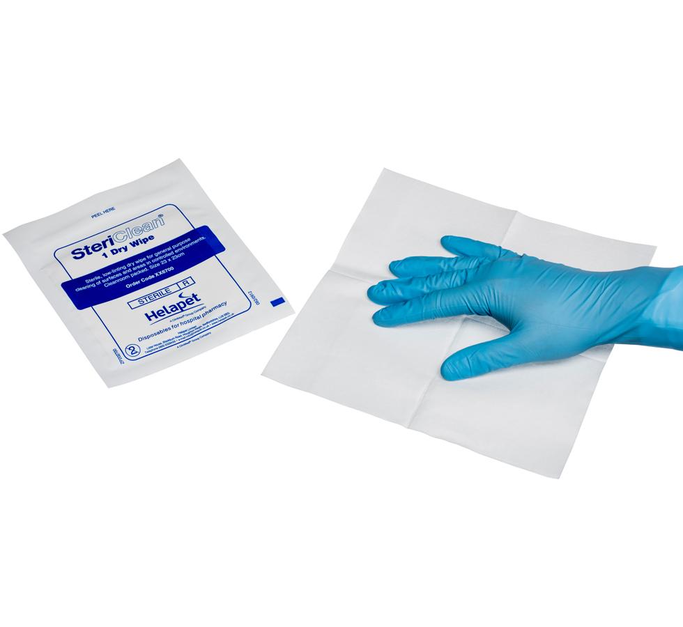 A Person with a Blue Gloved Hand Holding a White SteriClean® Dry Wipes (23 x 23cm) with a Blue and White Pack at the Side - Sentinel Laboratories Ltd